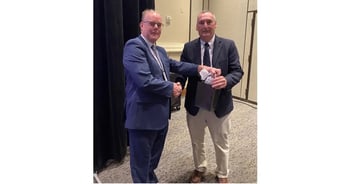 Eric Kemperman (Vice President of the PCMI and Research Manager of Etchform BV) presenting a gift to Mike Soble after presenting.